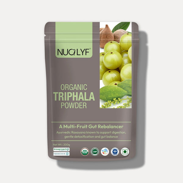 Organic Triphala powder pouch with illustrated Indian fruits on packaging for digestion support