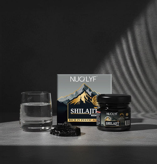 Nuolyf shilajit resin jar and box with a glass of water in dramatic lighting