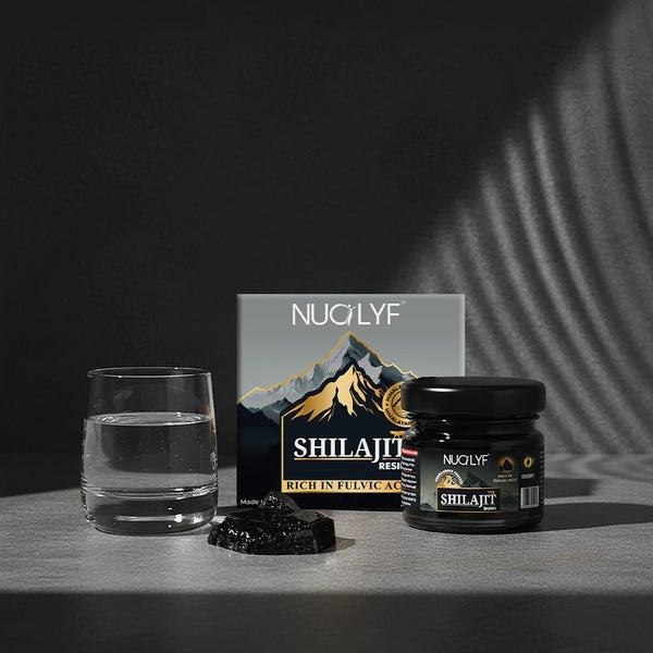 Nuolyf shilajit resin jar and box with a glass of water in dramatic lighting