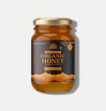 Glass jar of wild forest organic honey 500g with gold lid and mountain design label