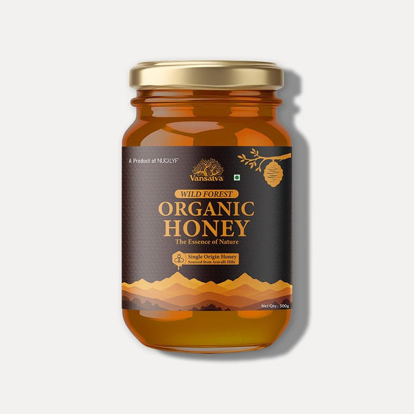 Glass jar of wild forest organic honey 500g with gold lid and mountain design label