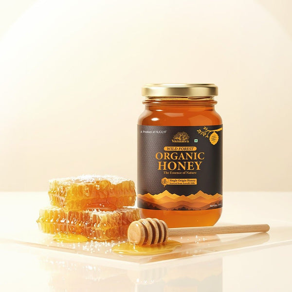 Jar of wild forest organic honey with honeycomb and dipper on a light background